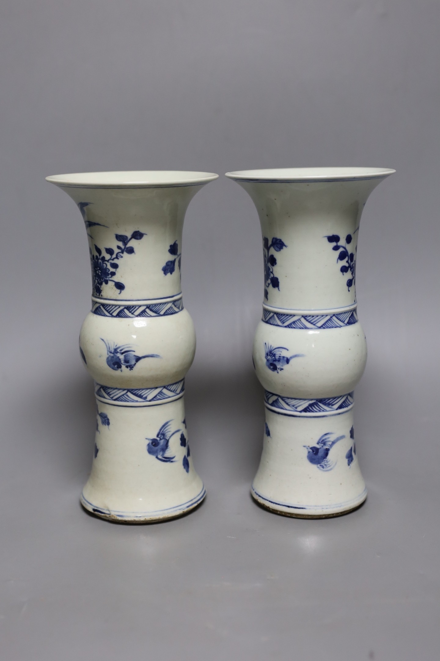 A pair of 19th century Chinese blue and white beaker vases, 23.5cm